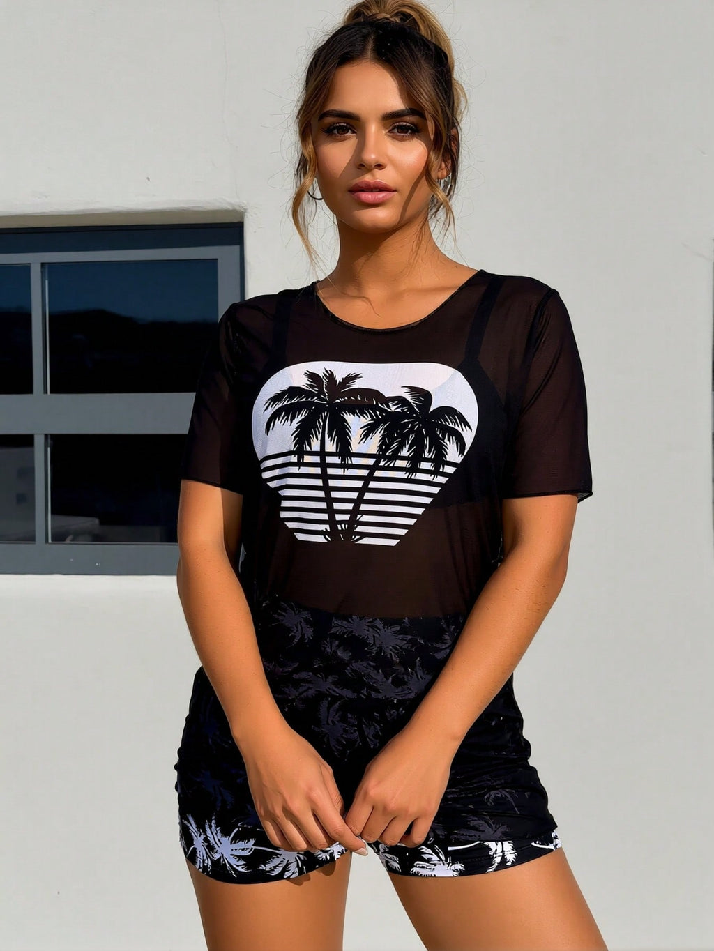 Black sheer swim cover-up with coconut palm graphic and short matching swim bottoms
