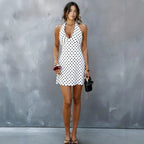 White halter V-neck mini dress with black polka dots