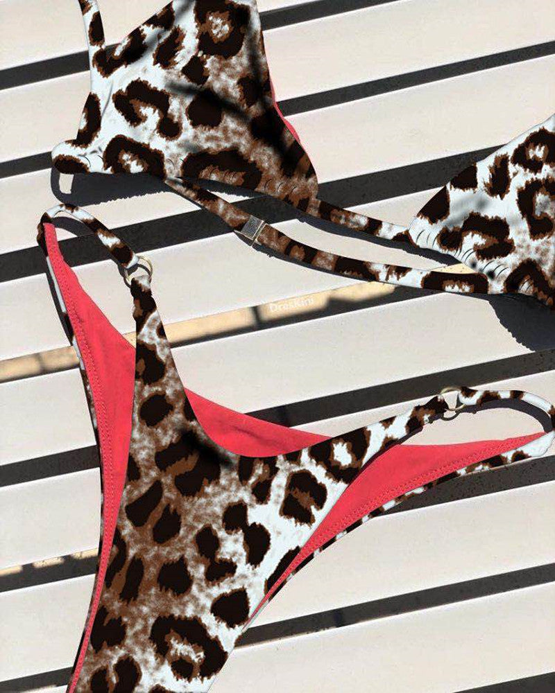 Leopard-print one-piece bikini with red piping, halter neckline, and side tie straps