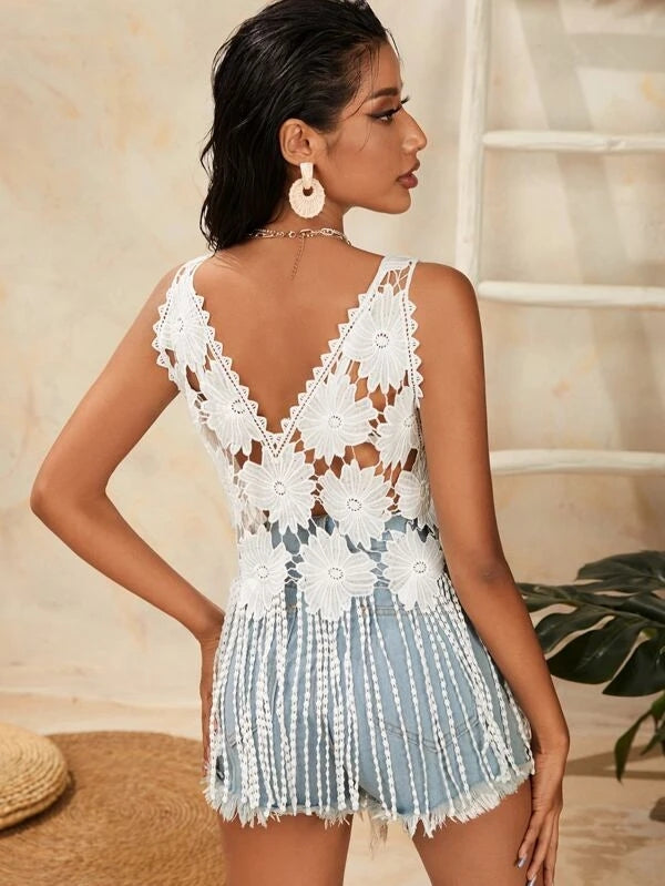 Backless white crochet mesh strap top with floral applique and blue tassel fringe hem