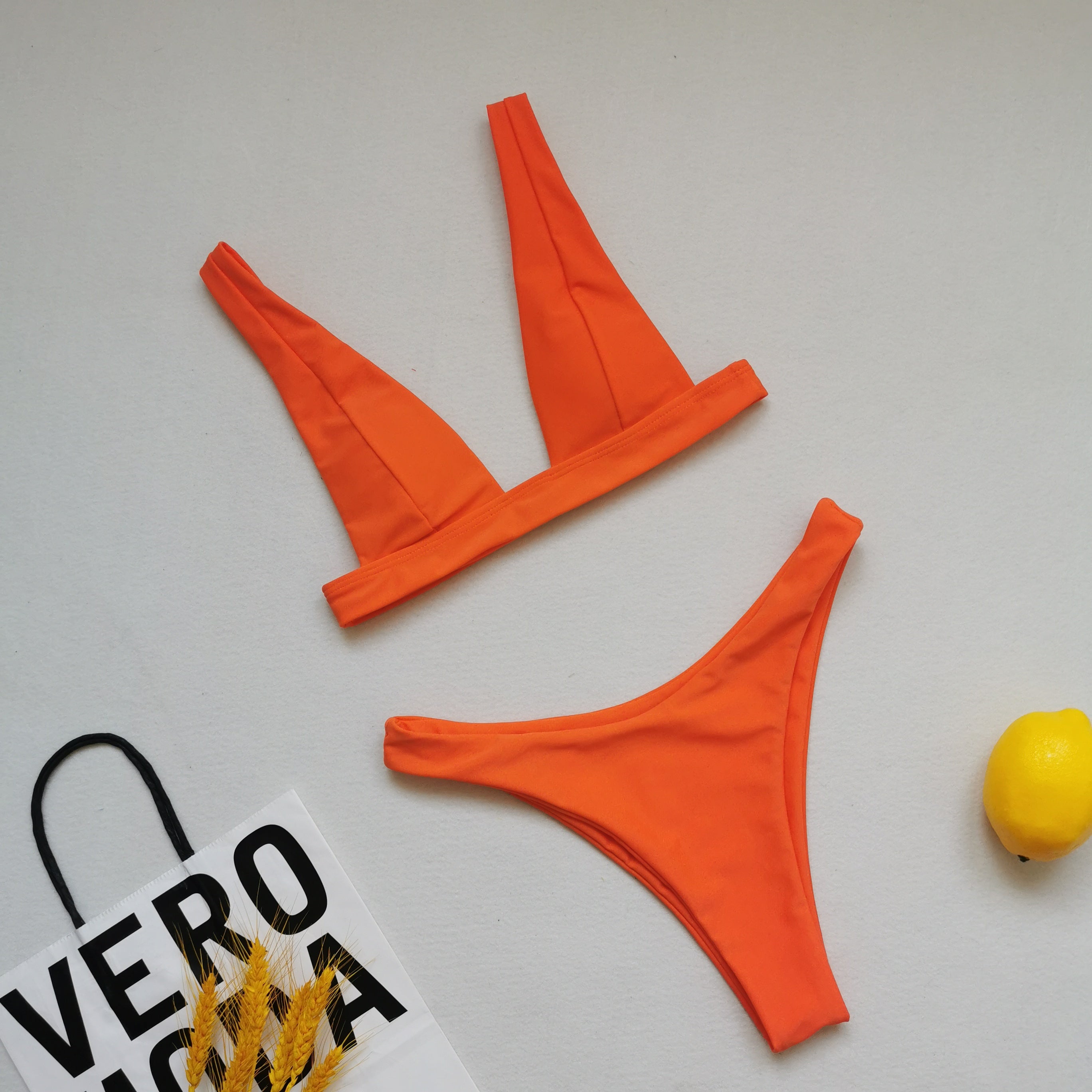 Orange double-sided bikini set with triangle V-neck top and high-cut bottoms