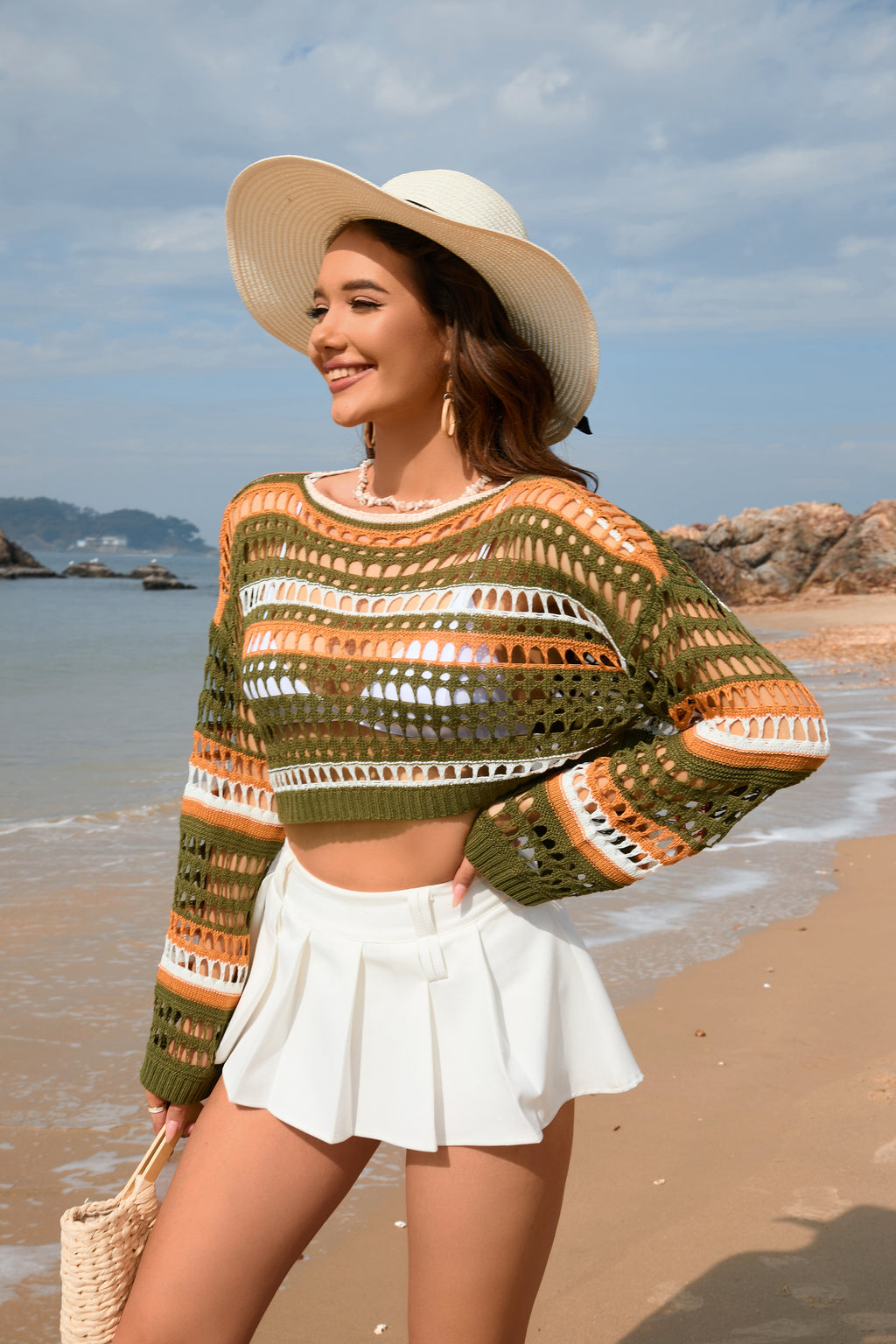Women’s green, orange, and white striped hollow-knit crop sweater with wide sleeves
