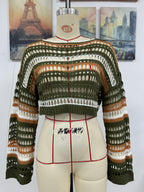 Women’s striped hollow-knit crop sweater on mannequin, green and orange accents