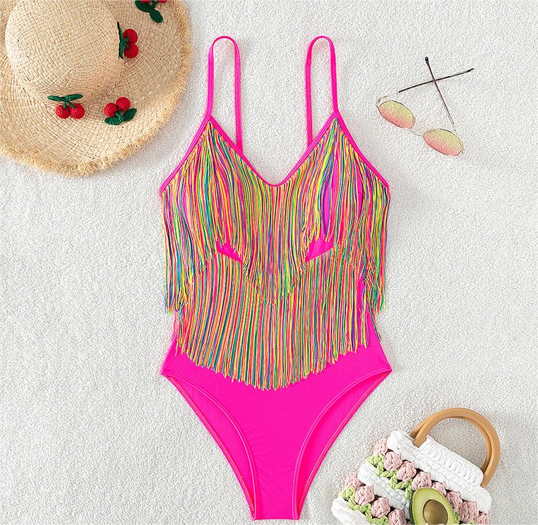 Pink one-piece swimsuit with rainbow striped fringe and thong-style bottom