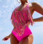 Bright pink one-piece swimsuit with rainbow fringe overlay and high-cut leg
