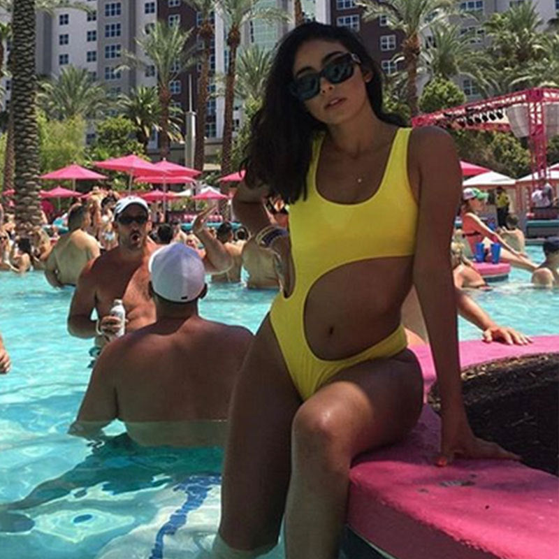Yellow one-piece solid swimsuit, sleeveless scoop neck and high-cut leg.