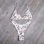 Leopard print triangle bikini top with Brazilian cut bottoms, white base and orange pattern