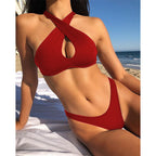 Red halter one-piece swimsuit with crisscross straps and oval bust cutout