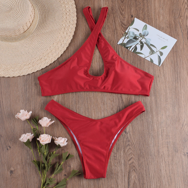 Red halter bikini-style one-piece with strap cross top and high-cut bottom