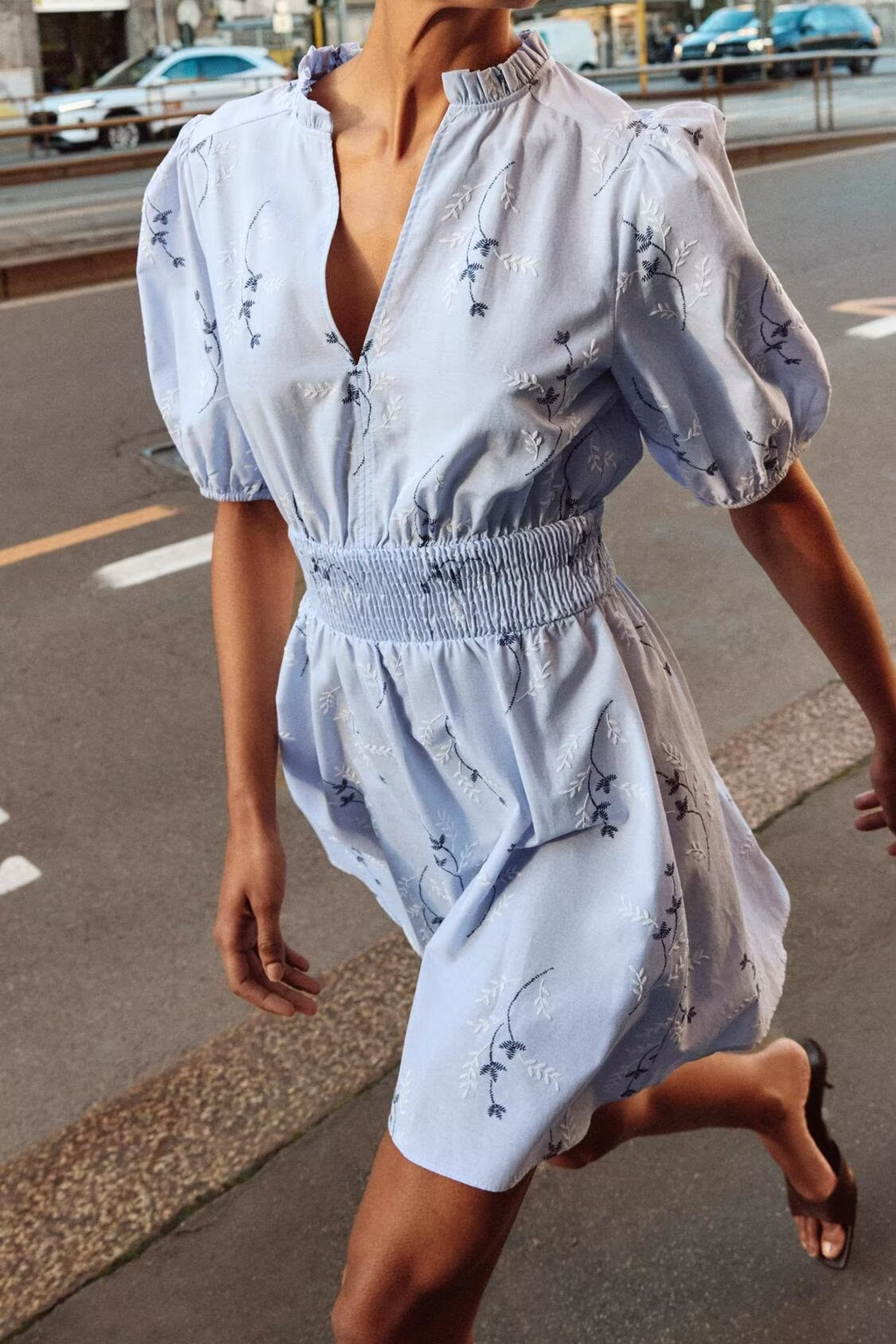 Light blue women's spring dress with puff sleeves, smocked waist, and navy animal print