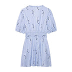 Light blue spring dress with short puff sleeves, gathered back, smocked waist, and navy animal print