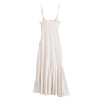 Off-white sleeveless maxi dress with spaghetti straps and gathered hem pleats
