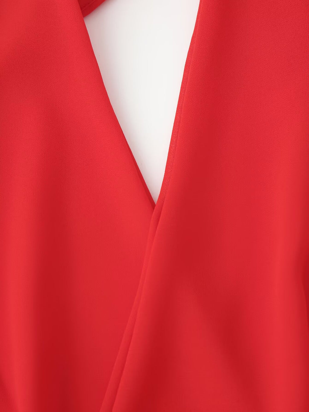 Red halter maxi dress bodice close-up with deep V cutout and wrap seams
