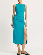 Teal sleeveless dress with pleated fabric, side slit, and gathered waist