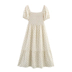 Cream short-sleeve dress with square neckline, puff sleeves, smocked waist and tiered skirt