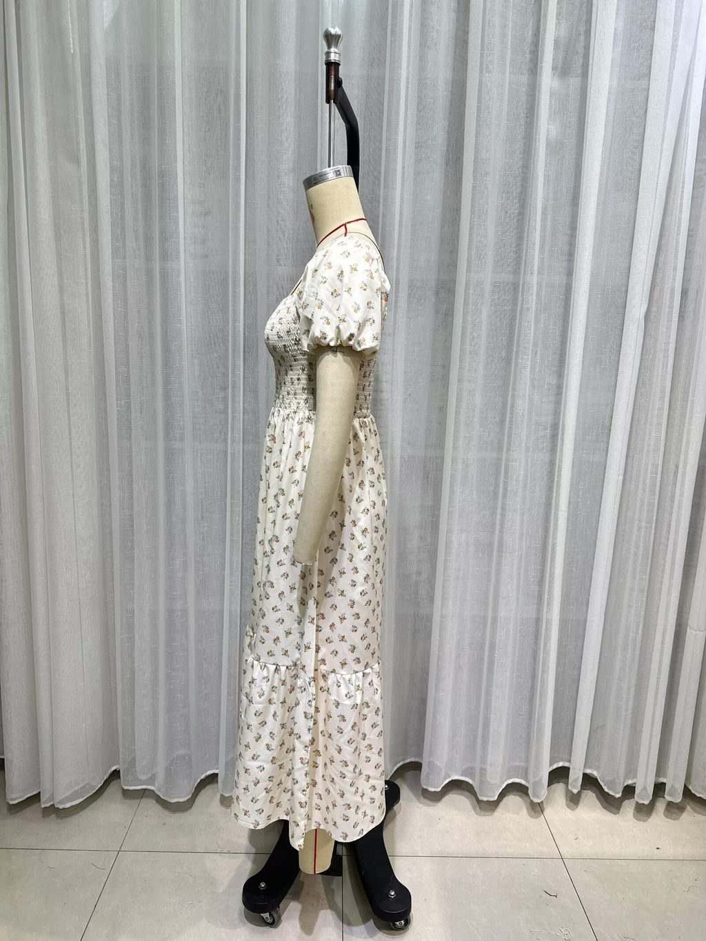 Cream short-sleeve dress detail view, puff sleeves, smocked waist, allover tiny print