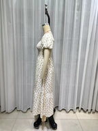 Cream short-sleeve dress detail view, puff sleeves, smocked waist, allover tiny print