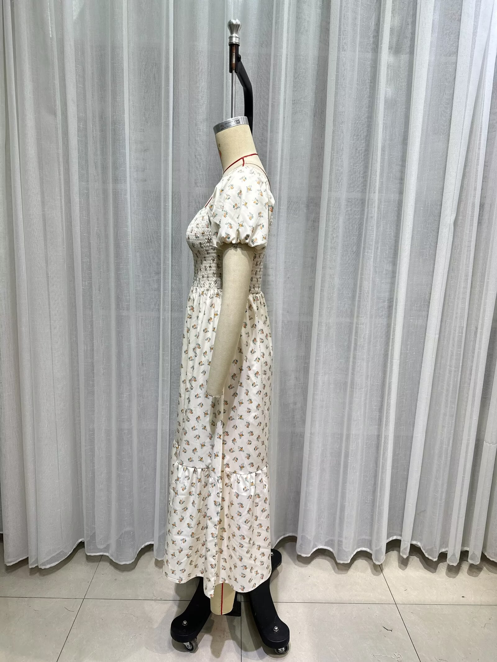 Cream short-sleeve dress detail view, puff sleeves, smocked waist, allover tiny print