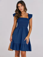 Women’s summer dress in navy blue with smocked bodice and tiered ruffle skirt