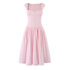 Pink sleeveless cocktail dress with buttoned bodice and tiered gathered skirt