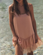 Pink lace satin slip dress with spaghetti straps and tiered lace-trimmed hem