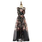 Floral sleeveless maxi dress in black with pink rose print and flared sheer skirt