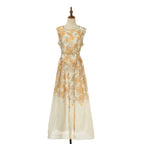 Floral sleeveless midi dress in light gold with fitted bodice and flowy skirt