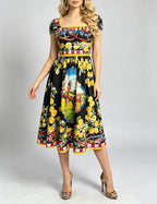 Halter bodycon midi dress with colorful citrus and portrait print on black