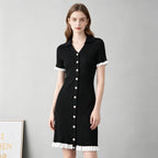 Black ribbed knit button-front dress with pointed collar, short sleeves, white ruffle trim