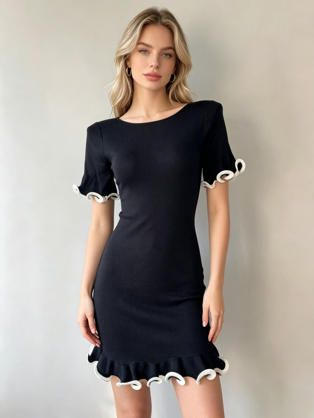 Black women's knit ruffled dress with short sleeves and scalloped ruffle hem