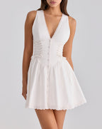 White sleeveless lace dress with V-neck and button front, gathered skirt