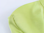 Green satin midi dress back with draped seam and smooth fabric