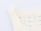 Cream knit mini dress with sleeveless arms and ribbed crew neck