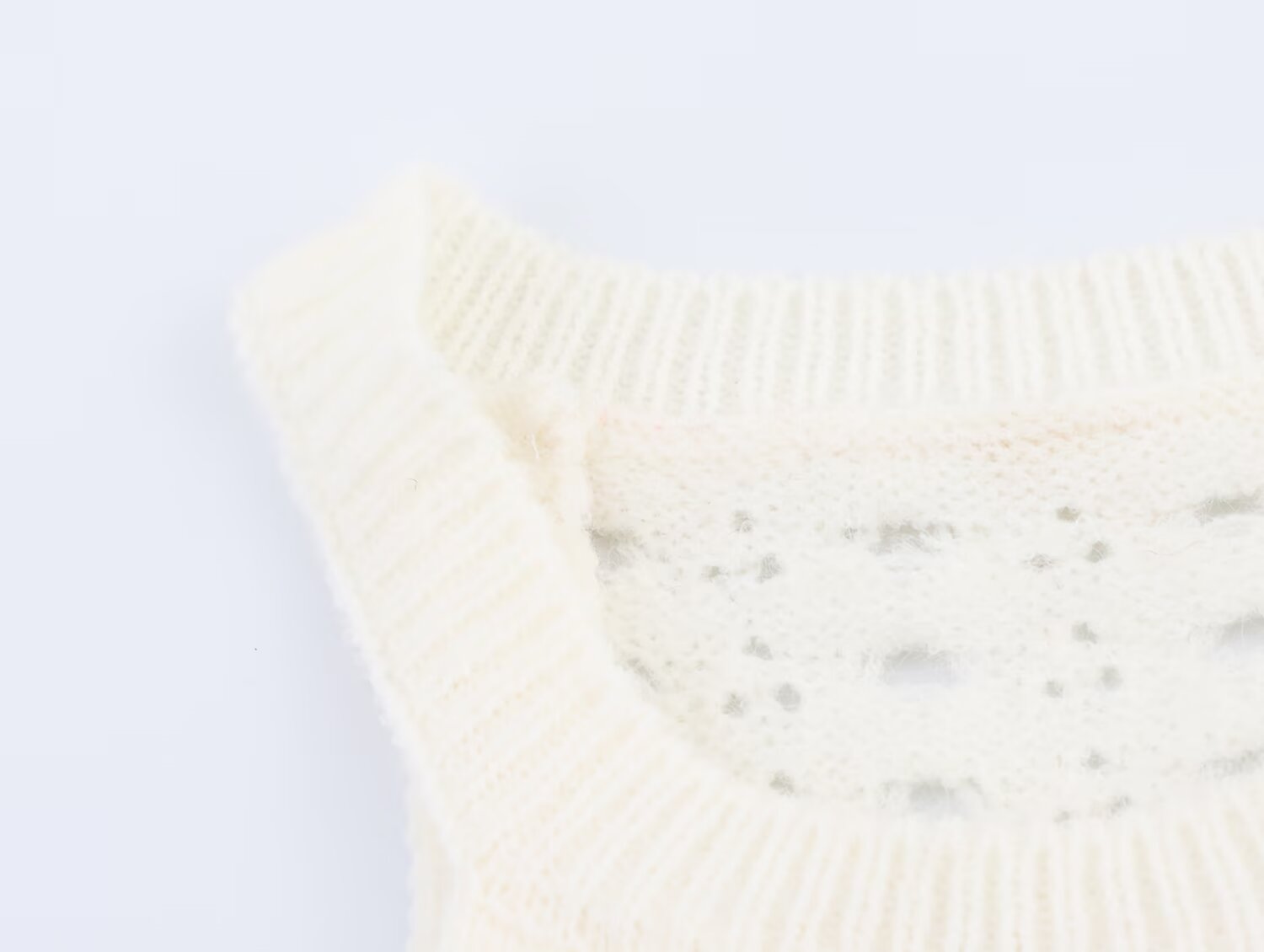 Cream knit mini dress with sleeveless arms and ribbed crew neck
