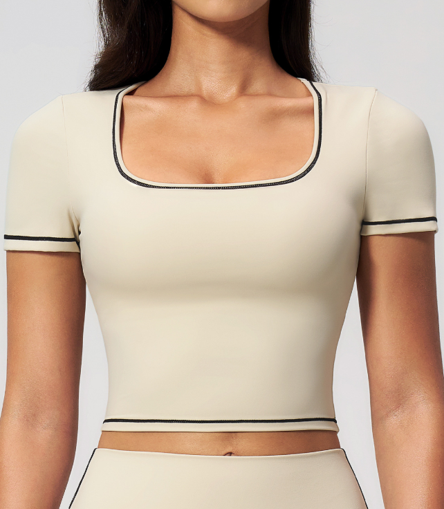 Beige cropped sports top with contrast trim and short sleeves