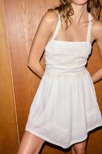 White mini summer dress, spaghetti straps, lace trim, gathered waist, scalloped hem