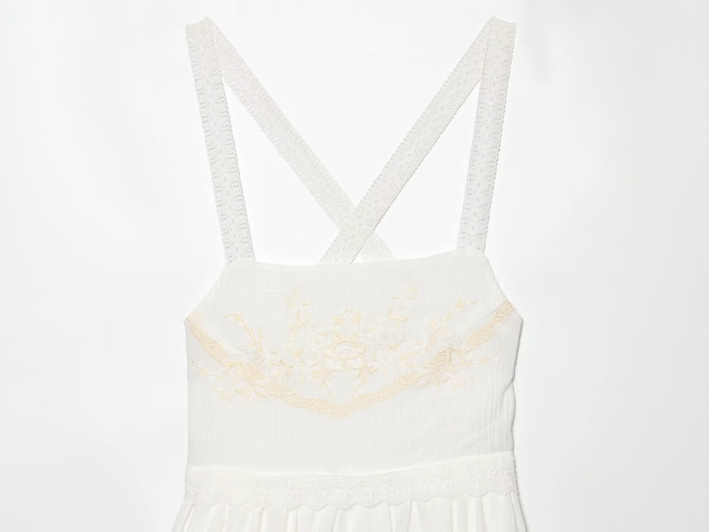 White mini summer dress bodice with cross-back spaghetti straps and embroidered bust detail