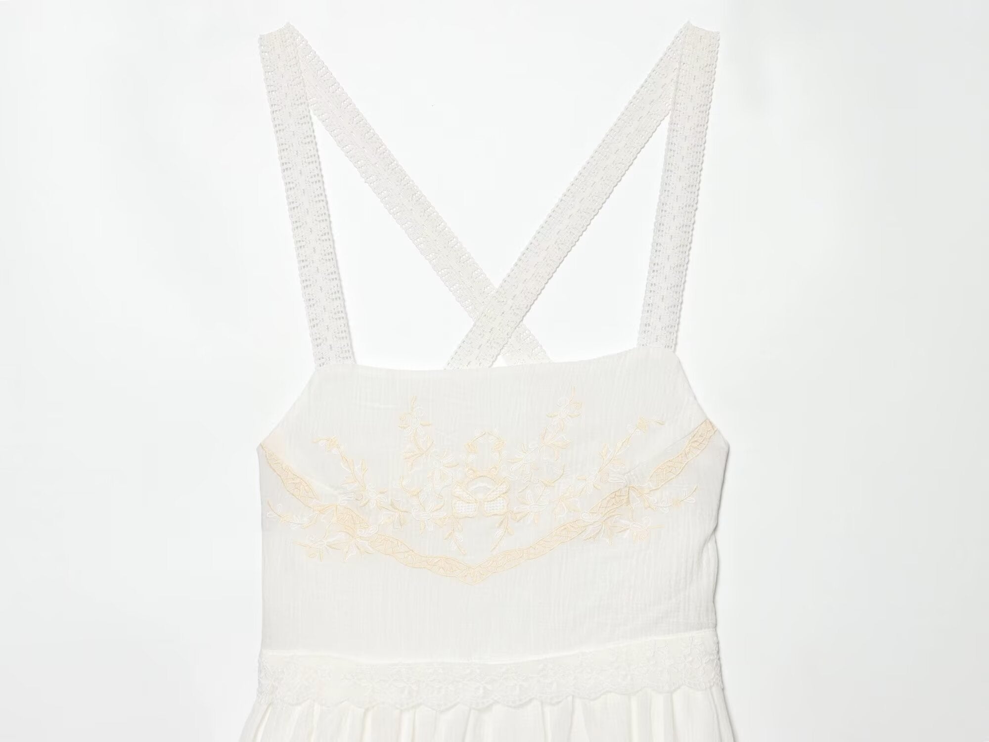 White mini summer dress bodice with cross-back spaghetti straps and embroidered bust detail