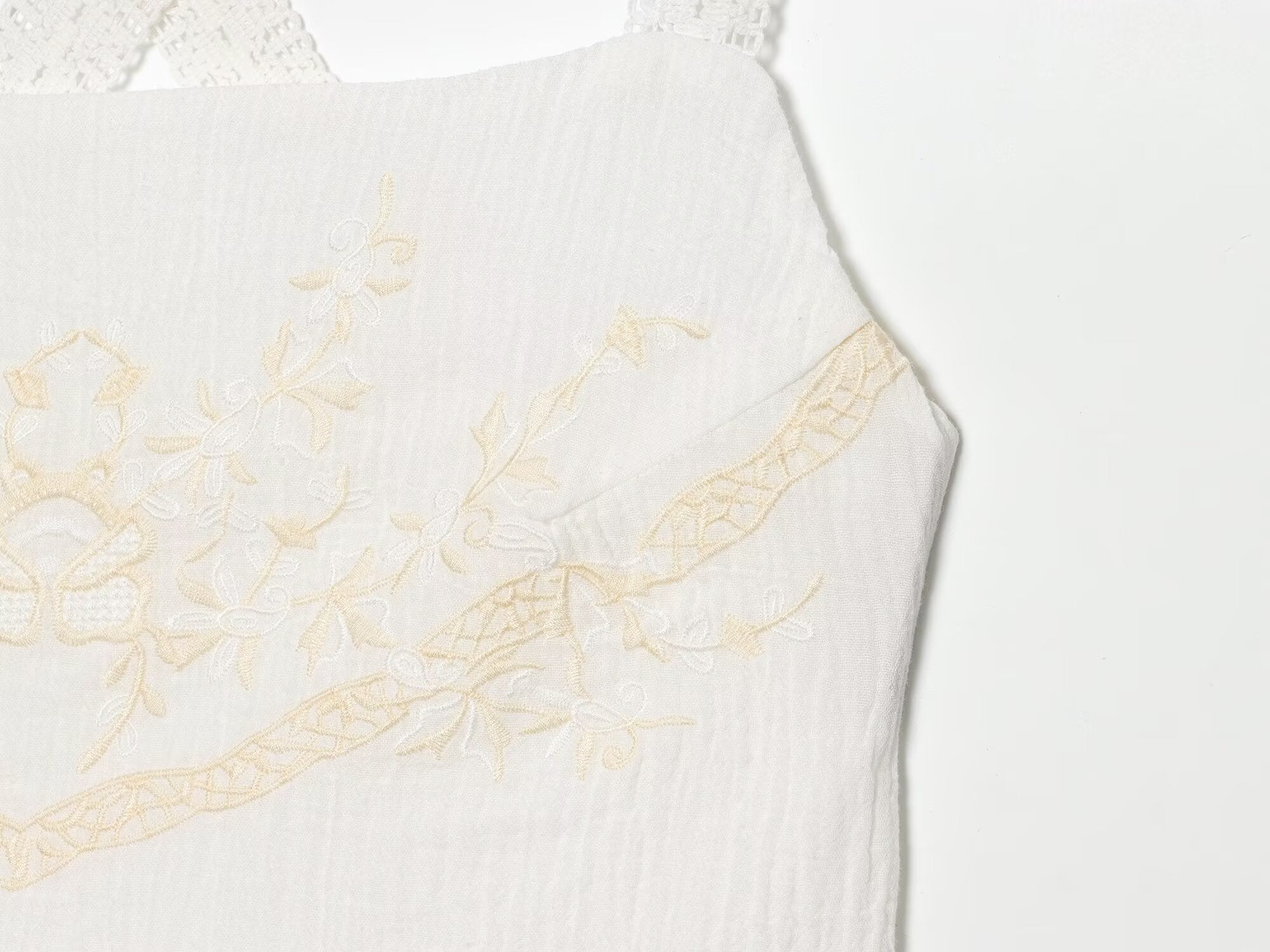 White mini summer dress with embroidered bodice and delicate shoulder straps