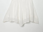 White mini summer dress with pleated skirt and scalloped lace hem