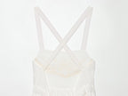 White mini summer dress with crisscross straps and square neckline