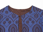 Blue embroidered dress close-up: brown button placket and round neckline