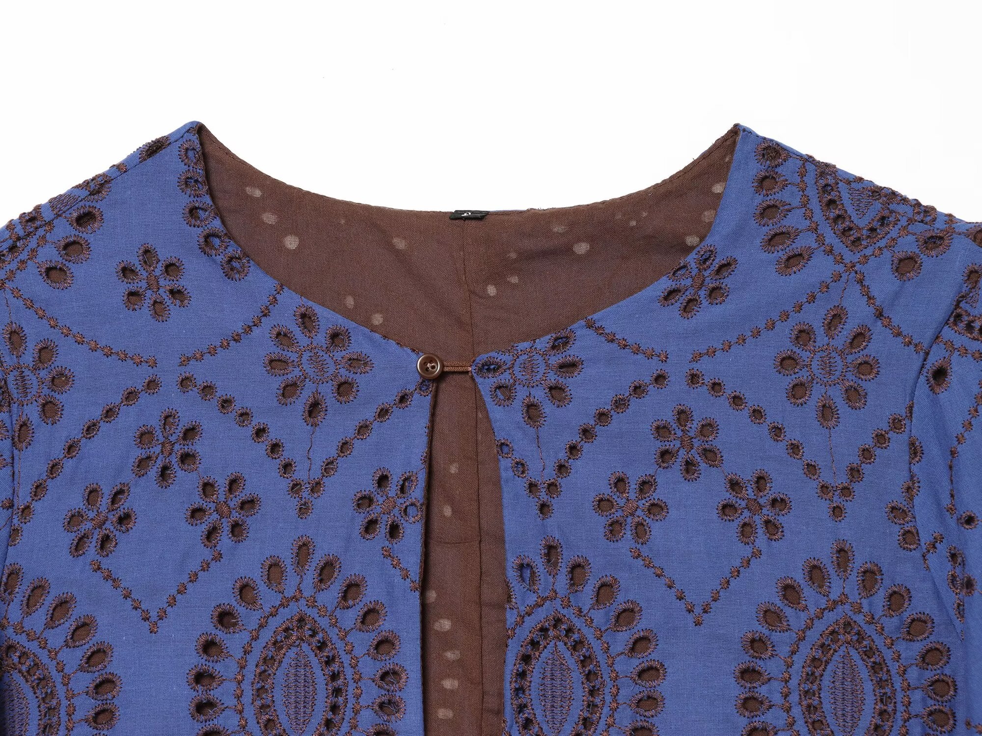 Blue embroidered dress close-up: brown button placket and round neckline
