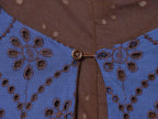 Blue embroidered dress close-up with brown button at keyhole neckline