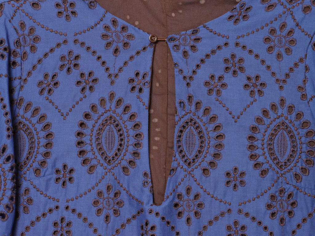 Blue embroidered dress close-up showing keyhole neckline and button detail