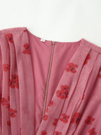 Pink dress close-up with red floral print, V-neck and front zipper