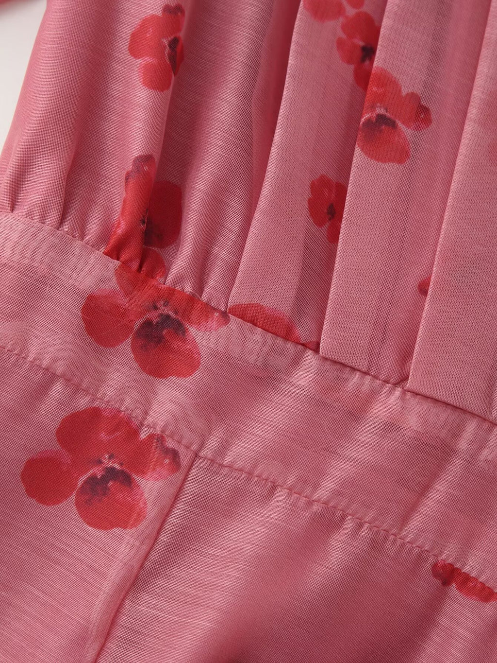 Pink floral dress close-up of gathered skirt with ruffled tiers