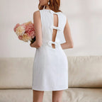 White women's elegant backless dress with keyhole cutout and bow-tie back