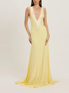 Yellow sleeveless maxi dress with V-neck and fitted bodice, flowing floor-length skirt