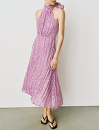 Violet polka-dot halter summer dress with ruffled neck and flowing midi skirt